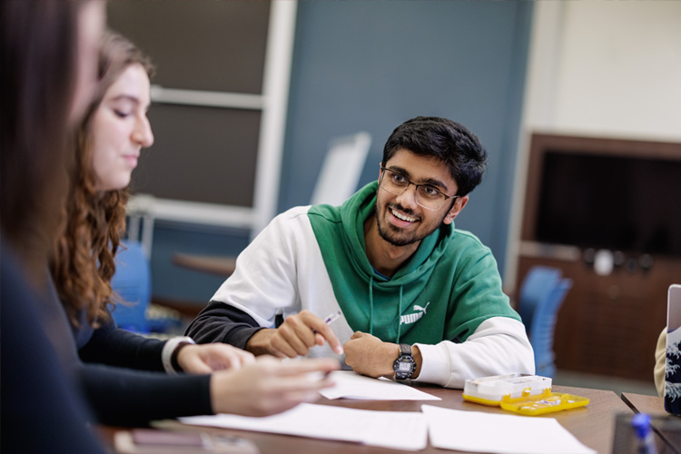 students in classroom sitting at table